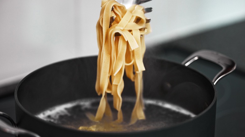 Pasta being removed from boiling water