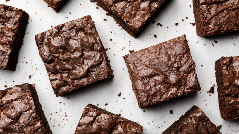 square cut chocolate brownies on a white background