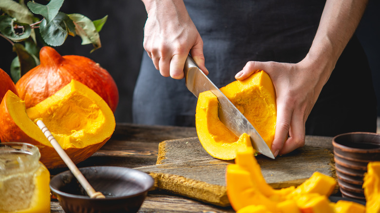 cutting a pumpkin into quarters