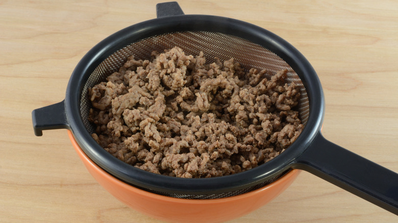 Ground beef in a colander