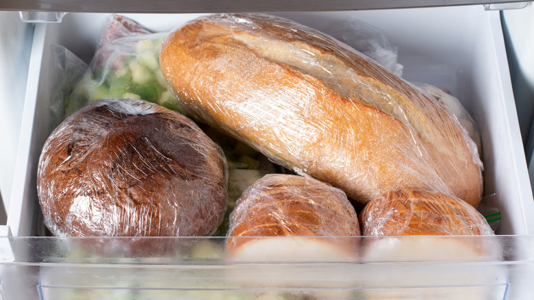 Wrapped bread loaves in refrigerator drawer