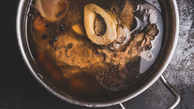 Pot of beef stock with marrow bones