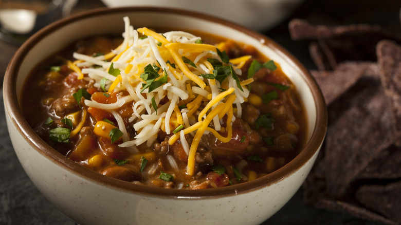 Bowl of chili with shredded cheese