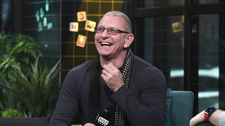 Robert Irvine with microphone and laughing