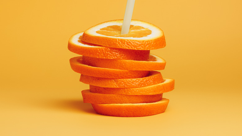 Stacked orange slices on orange surface