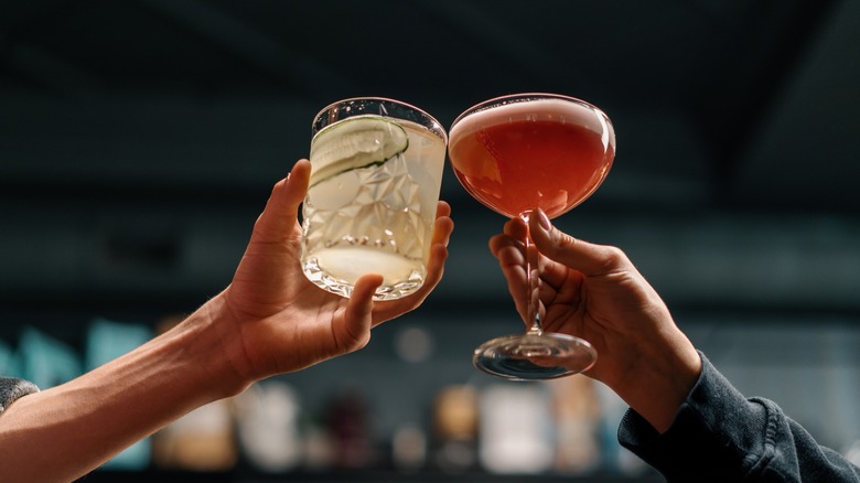 hands toasting with drinks