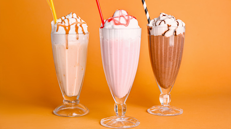 Three milkshakes with straws