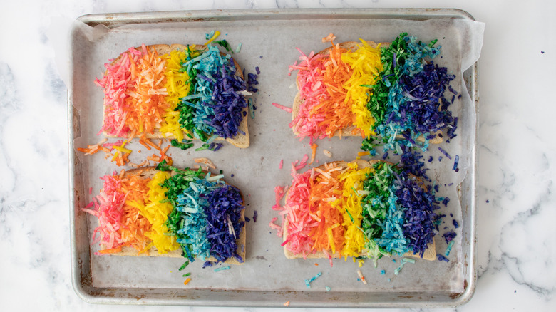 bread slices with strips of colorful shredded cheese