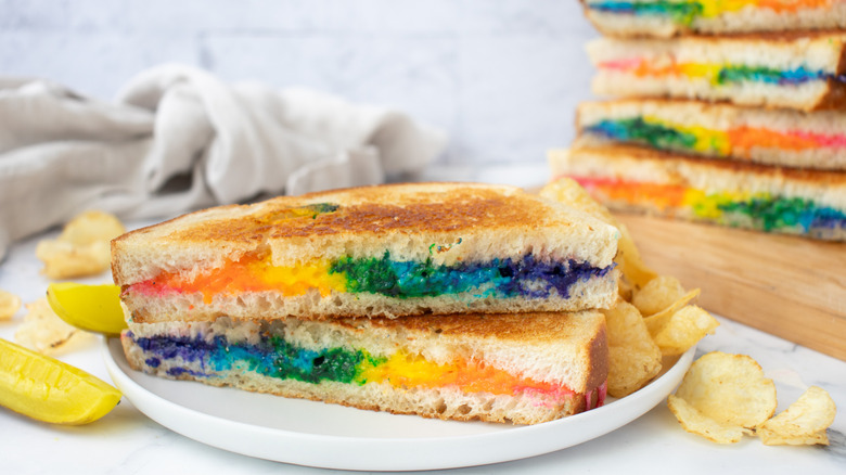 colorful rainbow grilled cheese halves stacked on plate