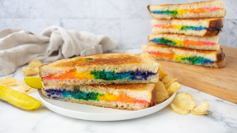 colorful rainbow grilled cheese halves stacked on plate