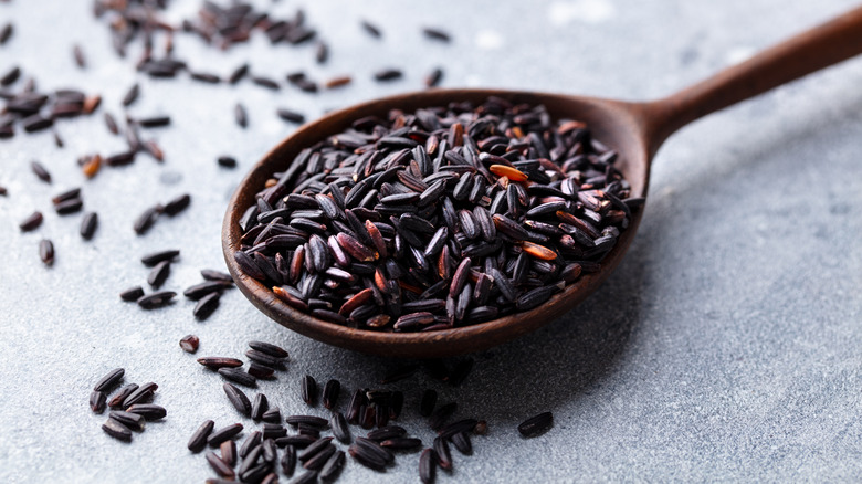 A spoon filled with wild rice