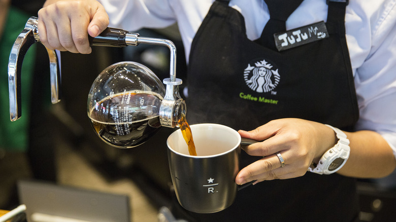 Starbucks Reserve worker pouring coffee