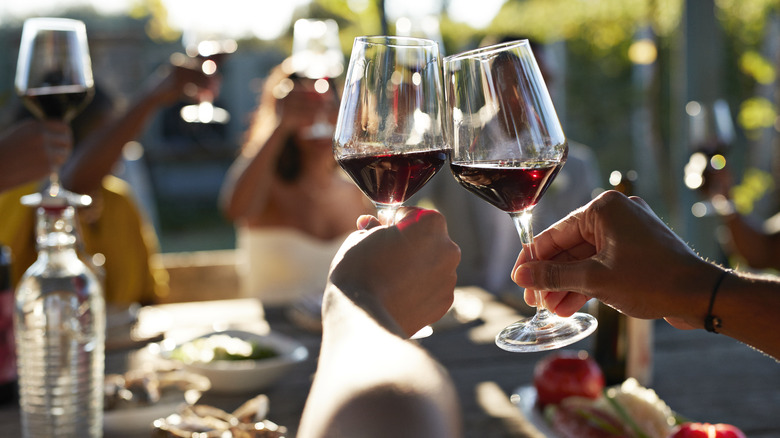 Hands holding glasses of wine