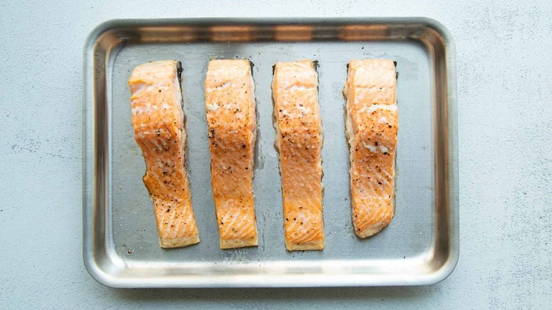 cooked salmon fillets on sheet pan