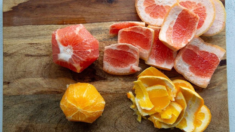 peeled orange and grapefruit on cutting board