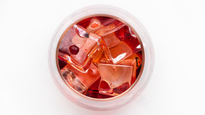 Rum, cranberry and ice in glass