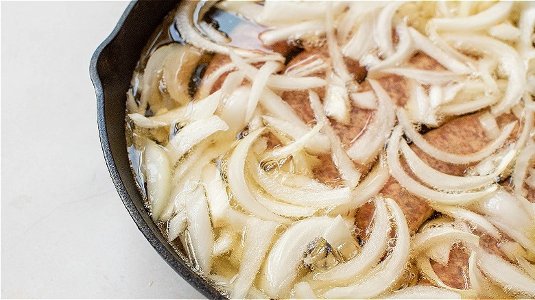 onions and beer in skillet