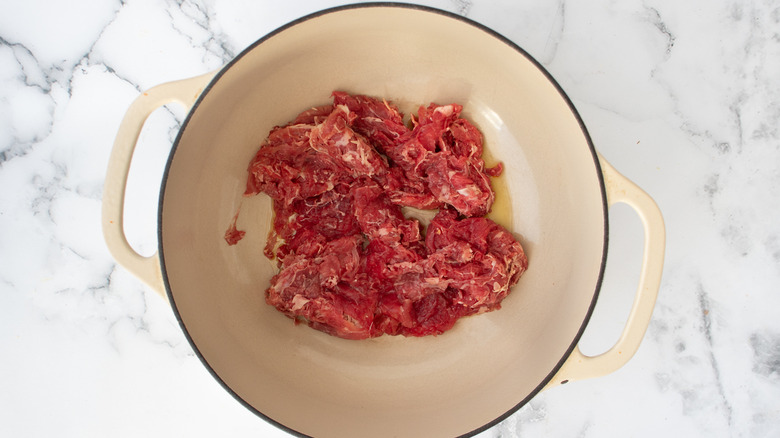 sliced sirloin in pot cooking