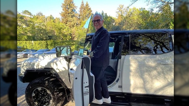 Wolfgang Puck standing on a white Hummer EV