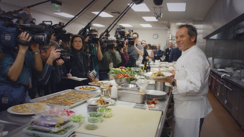 Wolfgang Puck in the kitchen with the press