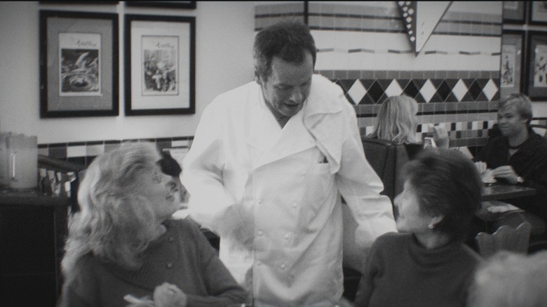 Wolfgang Puck talking with customers