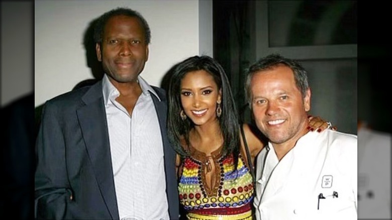 Wolfgang Puck and wife smiling with Sidney Poitier 