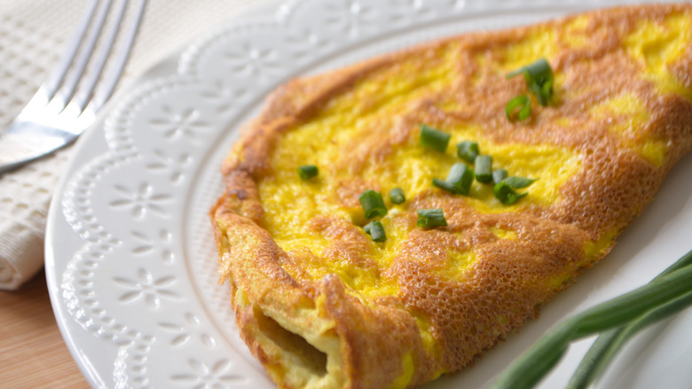 Omelette on white plate with fork