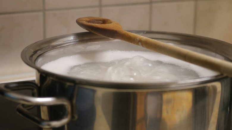 wood spoon over boiling water