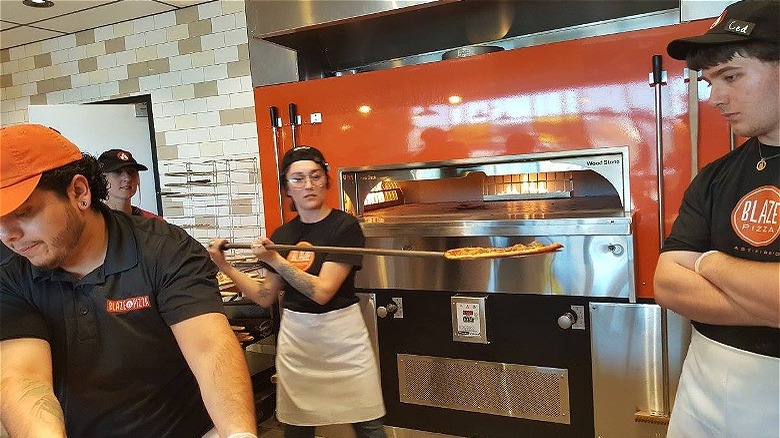 Employee at pizza oven