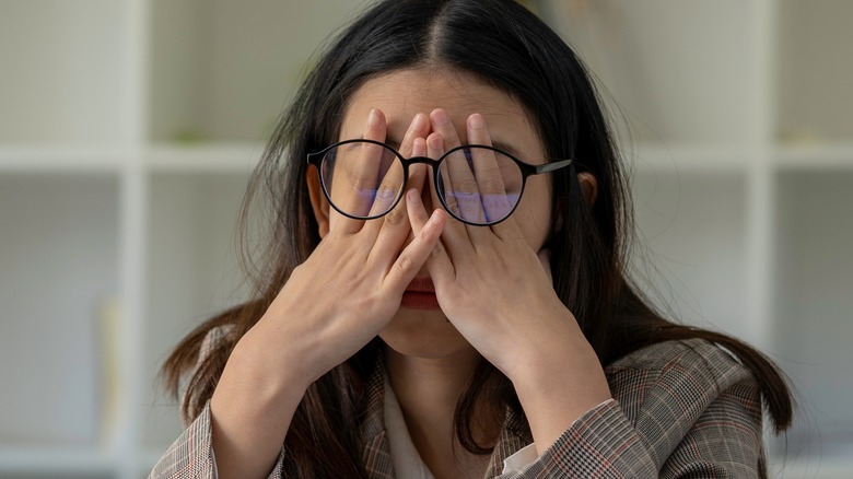 frustrated woman holding face