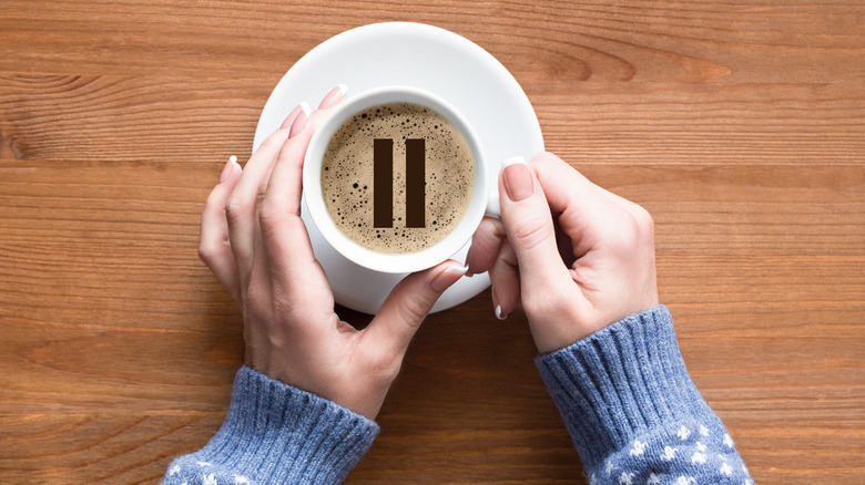 hands holding coffee cup