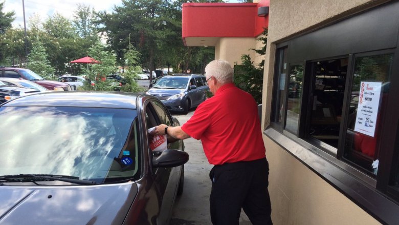 employee serving drive-thru customer