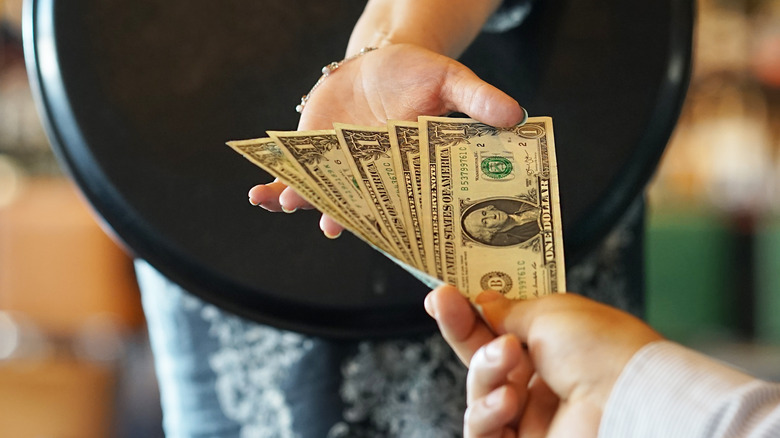 waitress receiving cash tip