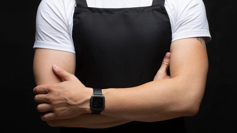 waiter with crossed arms and watch