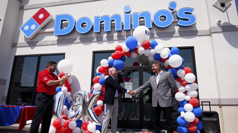 Handshake in front of Domino's store