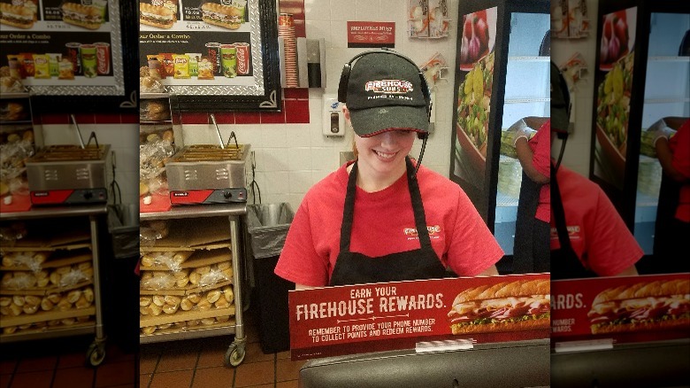 An employee behind the counter at Firehouse Subs