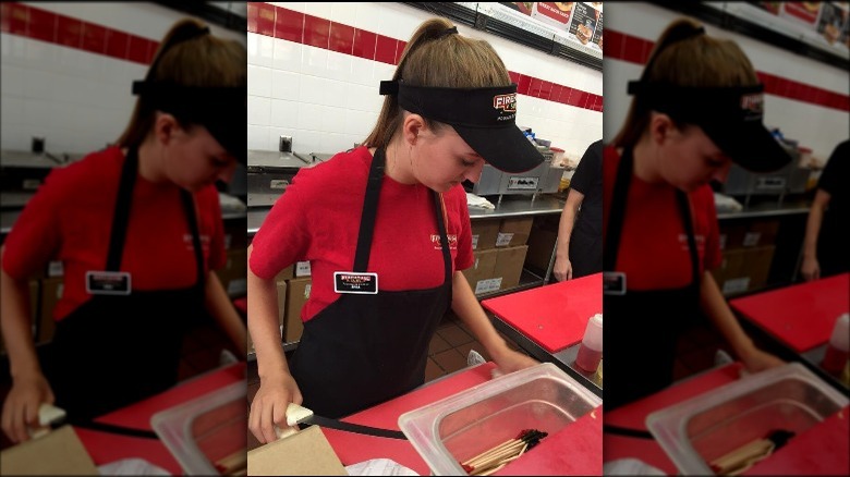 A Firehouse Subs employee in uniform.