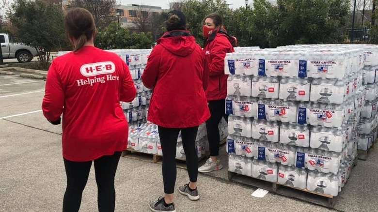 H-E-B workers with cases of water