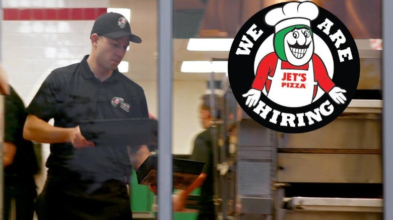 Jet's Pizza employee carrying tray