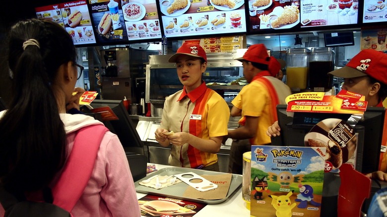 Customer ordering at Jollibee counter