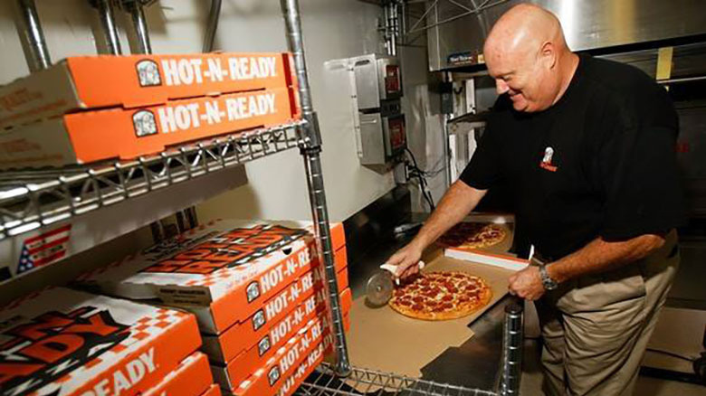 Smiling pizza worker