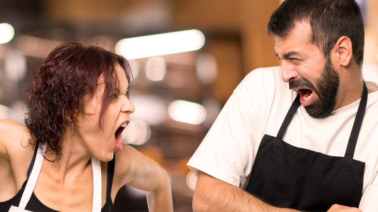 servers in aprons arguing