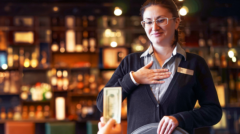 shocked waitress receiving cash