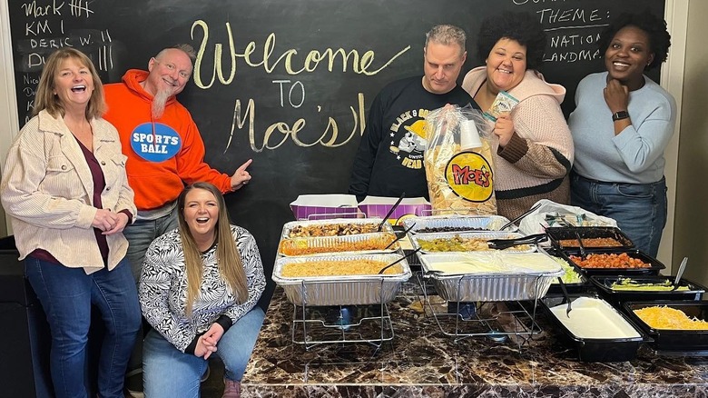 Moe's employees smiling with food