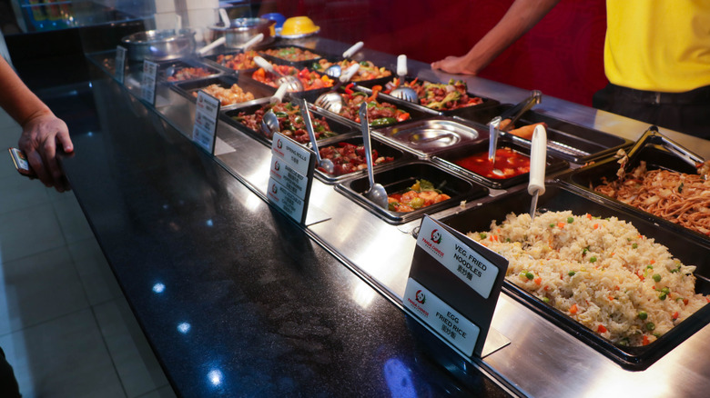 Panda Express offerings in bins with serving utensils