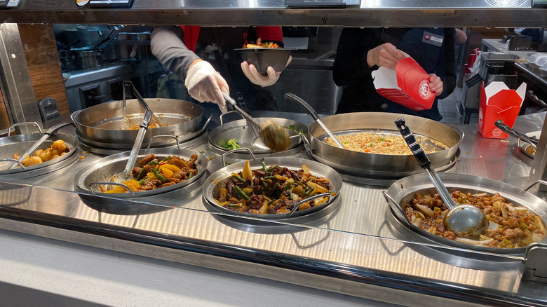 Panda Express workers preparing to-go order