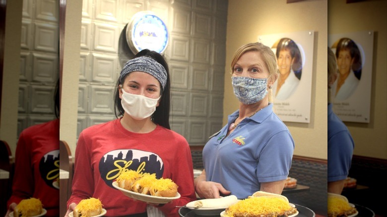 Masked employees serving food