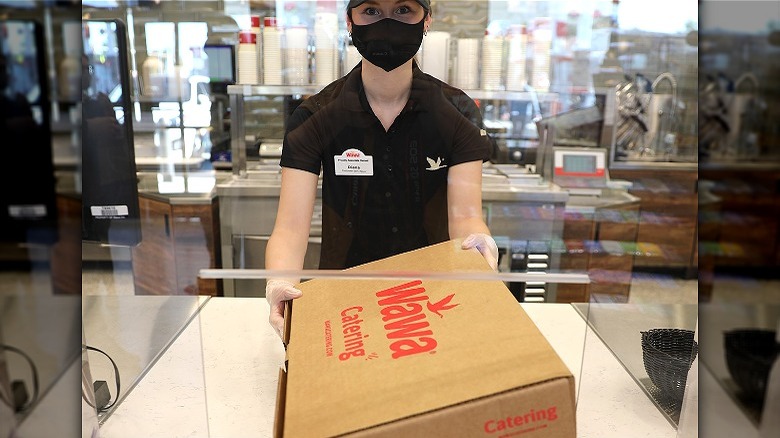 Worker in mask front counter