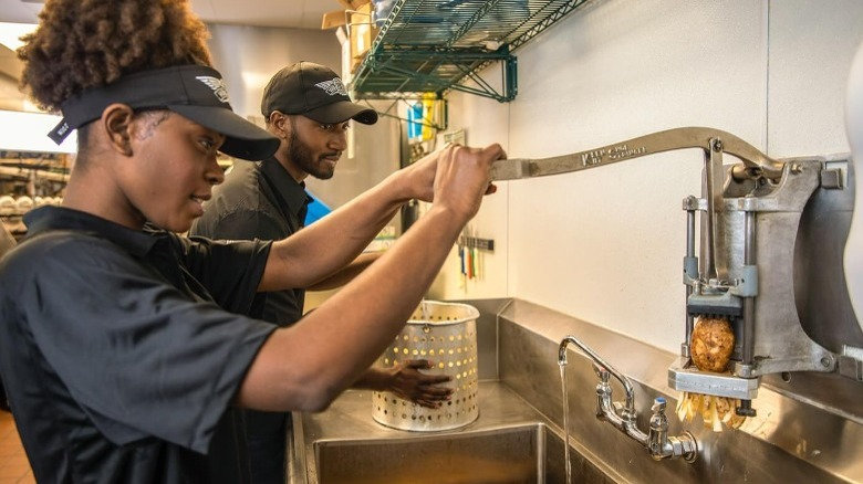 Two Wingstop employees making fries