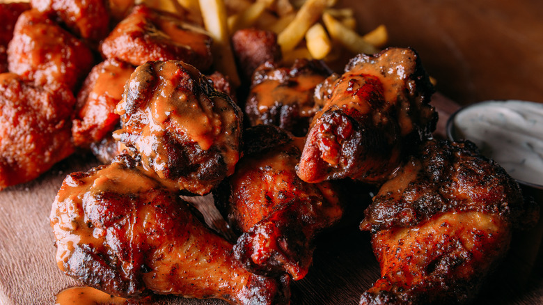 Some buffalo wings and fries 